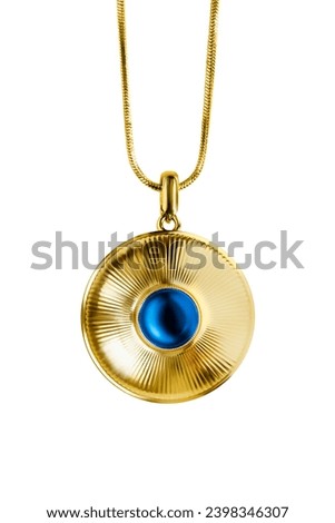 Large golden pendant with blue sapphire gem hanging on a chain on white background