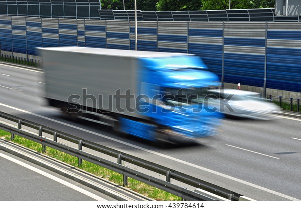 Large goods vehicle moving at full speed on\
six lane controlled-access\
highway.\
\
