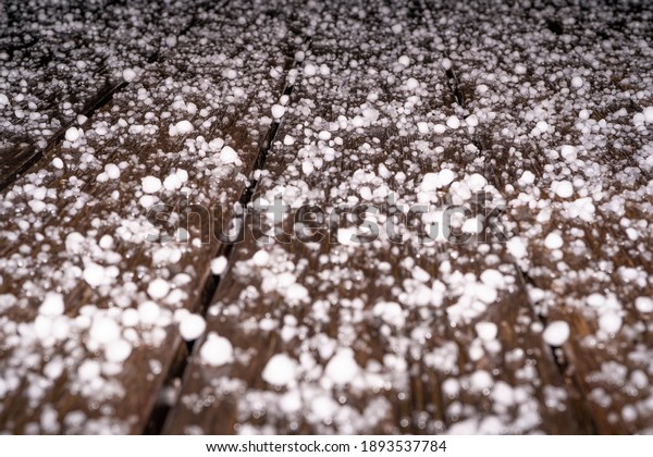 Large grains of hail on a black background.\
Background, texture. After Heavy Storm with Hail on the terrace in\
the night. Hight quality\
photo