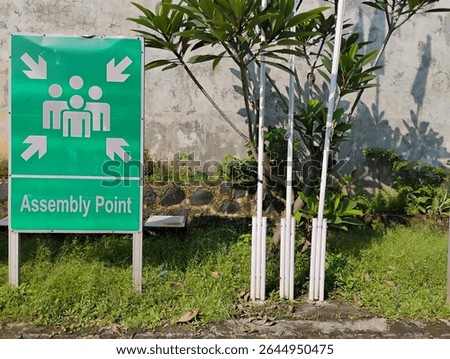 large green square assembly point sign