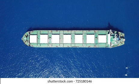 Large GREEN-WHITE deck bulk carrier ship sailing in open ocean
