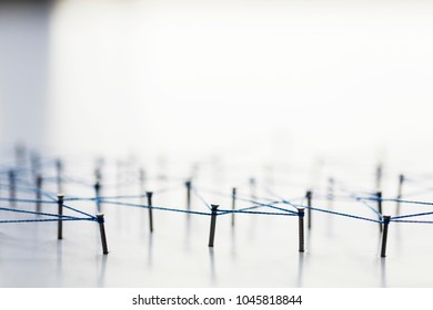 A large grid of pins connected with string. Communication, technology, network concept