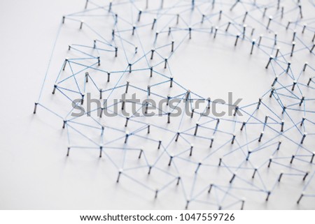 A large grid of pins connected with string. Communication, technology, network concept