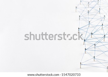 A large grid of pins connected with string. Communication, technology, network concept