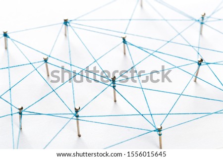 A large grid of pins connected with string. Communication, technology, network concept