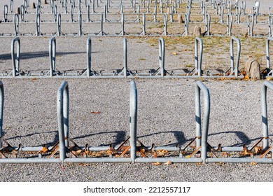 Large Group Of Bike Racks In Bracket Shape On A Large Public Parking Area.