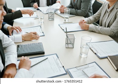 Large Group Of Business Partners Or Colleagues Or Conference Participants Learning Financial Papers Or Contract At Meeting In Boardroom