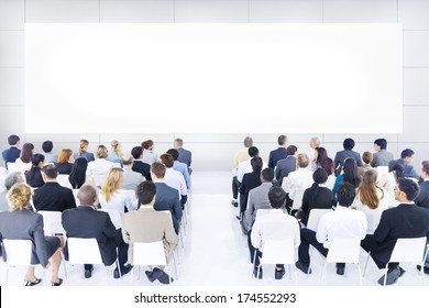 Large Group Of Business People In Presentation.