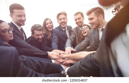 large group of business people standing with folded hands together - Shutterstock ID 1205014837