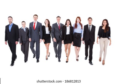 Large Group Of Business People Walking Towards Camera. Isolated On White