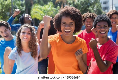 Large Group Of Cheering Young Adults