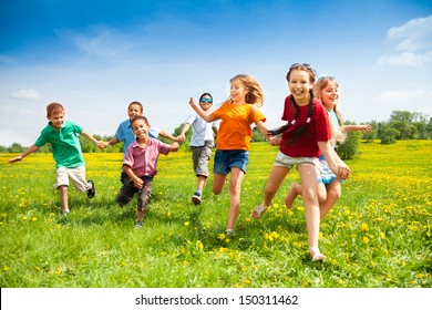 Large group of children running in the dandelion spring field - Shutterstock ID 150311462