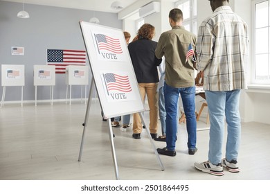 Large group of diverse people registering at polling station holding American flags in hands on election day. American voters standing in queue at vote center going to put ballots in voting booth. - Powered by Shutterstock