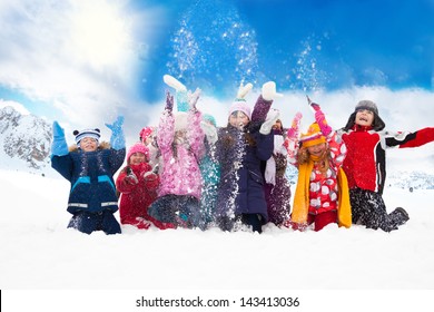 Large Group Of Diversity Looking Kids Boys And Girls Throwing Snow In The Air Together