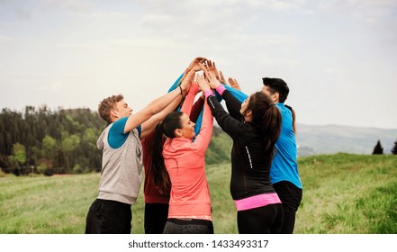 Large group of fit and active people resting after doing exercise in nature. - Powered by Shutterstock