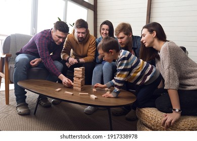 A Large Group Of Friends Plays Board Games, A Cheerful Company At Home. High Quality Photo