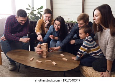 A Large Group Of Friends Plays Board Games, A Cheerful Company At Home. High Quality Photo