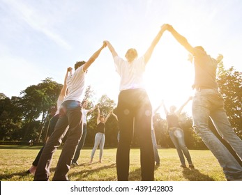 large group of friends together in a park having fun - Powered by Shutterstock