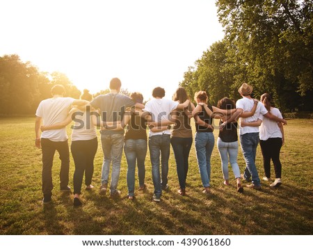 large group of friends together in a park having fun