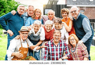 Large group of happy senior men and women taking selfie pic at private villa - Retired people having fun together on garden party mood - Positive elderly life style concept on bright warm vivid filter - Powered by Shutterstock