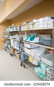 Large Group Of Hospital Supplies Arranged On Trollies In Storage Room