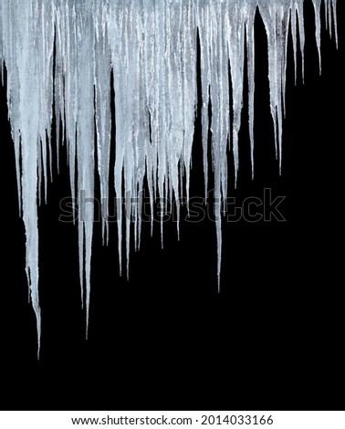 large group of icicles isolated on black background