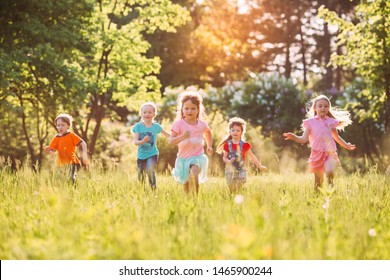 Large group of kids, friends boys and girls running in the park on sunny summer day in casual clothes  - Shutterstock ID 1465900244
