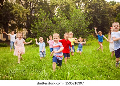 Large Group Of Kids Running In The Park