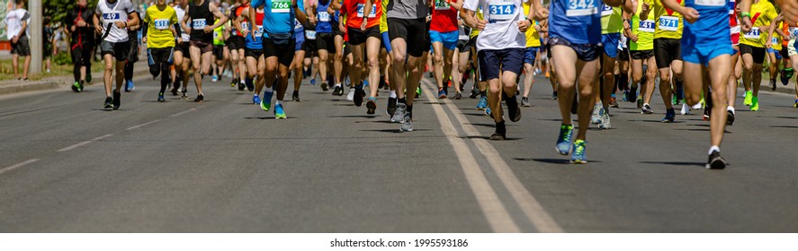 Large Group Of Leg Runners Athletes Run Urban Marathon