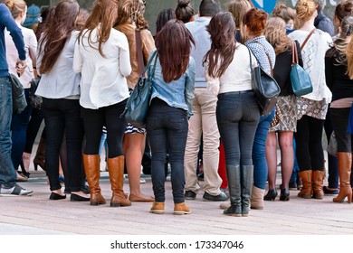 A Large Group Of Men And Women. Urban Scene.