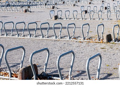 Large Group Of Modern Bike Racks In Bracket Shape On A Large Public Parking Area.