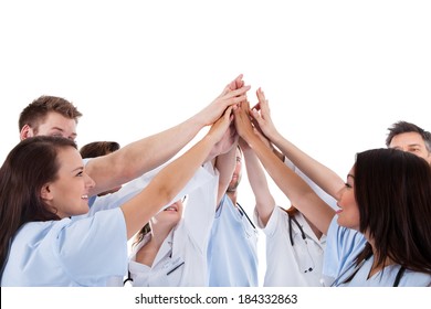 Large Group Of Motivated Doctors And Nurses Standing In A Circle Giving A High Fives Gesture With Their Hands Meeting In The Centre  Conceptual Of Teamwork Isolated On White