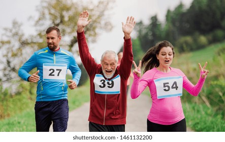 Large group of multi generation people running a race competition in nature. - Shutterstock ID 1461132200