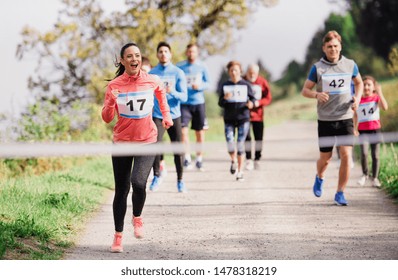 Large group of multi generation people running a race competition in nature. - Powered by Shutterstock