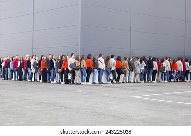 Large group of people waiting in line - Shutterstock ID 243225028