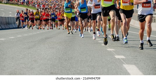 large group runners leading marathon race - Shutterstock ID 2169494709