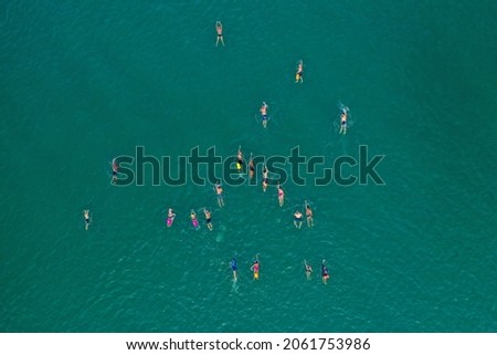 Large group of Swimmers crossing the Sea of Galilee, Aerial view.