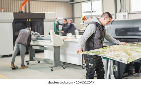 Large group of worker printmaker technician operator works in digital printing press hall and printshop office with many different type of machine - Powered by Shutterstock