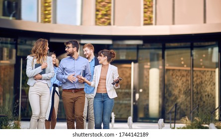 Large Group Of Young Businesspeople Walking Outiside The Building