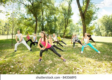 Large Group Of Young People Stretching Outdoor