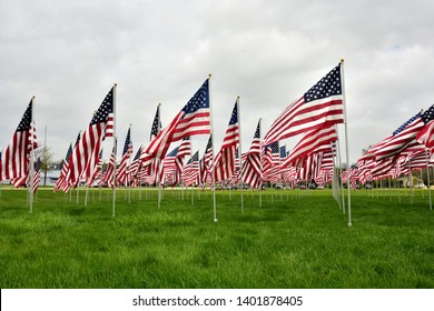 A large grouping of waiving US Flags display showing horror and support for Memorial Day. 
