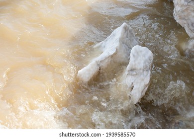 Large Gypsum Rock Or Stone Surrounded By Water. Big Wet Calcite Washed In The River Shore With Lots Of Waves. Semi Precious White Gem Deposit Or Mining