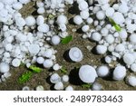 Large hail, balls of ice on the ground after hailstorm