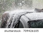 Large hail stones pelting car roof during storm