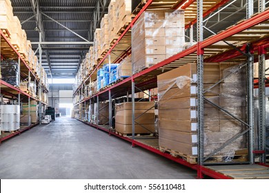 Large hangar warehouse industrial and logistics companies. Boxes and containers with goods placed on high shelves.