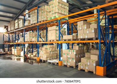Large hangar warehouse of industrial and logistics companies. Long shelves with a variety of boxes.