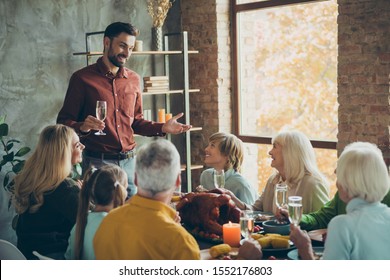 Large Happy Familly Gathering On October Event Party Thanksgiving Day Sit Table Enjoy Meal Roast Meat Corn Man Stand Hold Champagne Glass Toast To Small Little Kids Mature People Clink In House