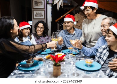 Large happy multi generational spanish family enjoying christmas dinner celebration at home - Powered by Shutterstock