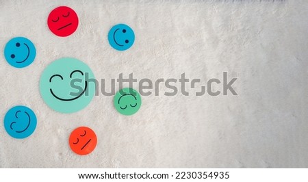 Large happy smiley face paper cut which is among various emotions, good feedback rating and positive customer review, experience, satisfaction survey ,mental health positive life concept. Foto d'archivio © 