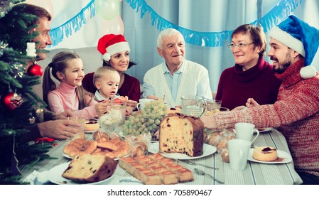 Large Happy Spanish Family Talking Animatedly During Christmas Dinner
